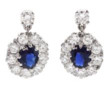 Pair of 18ct white gold oval sapphire and round brilliant cut diamond cluster