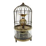 Automation bird cage clock of predominantly brass construction with central rotating orb and two bir