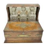 Edwardian oak tantalus with brass mounts and handles