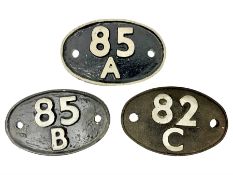 One cast iron and two metal carriage number plates