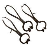 Three pairs of Georgian wrought iron spring loaded sugar nips each terminating in curved blades
