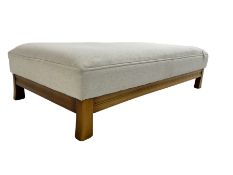 Large rectangular stained beech footstool upholstered in cream fabric