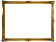 Large swept gilt-framed mirror