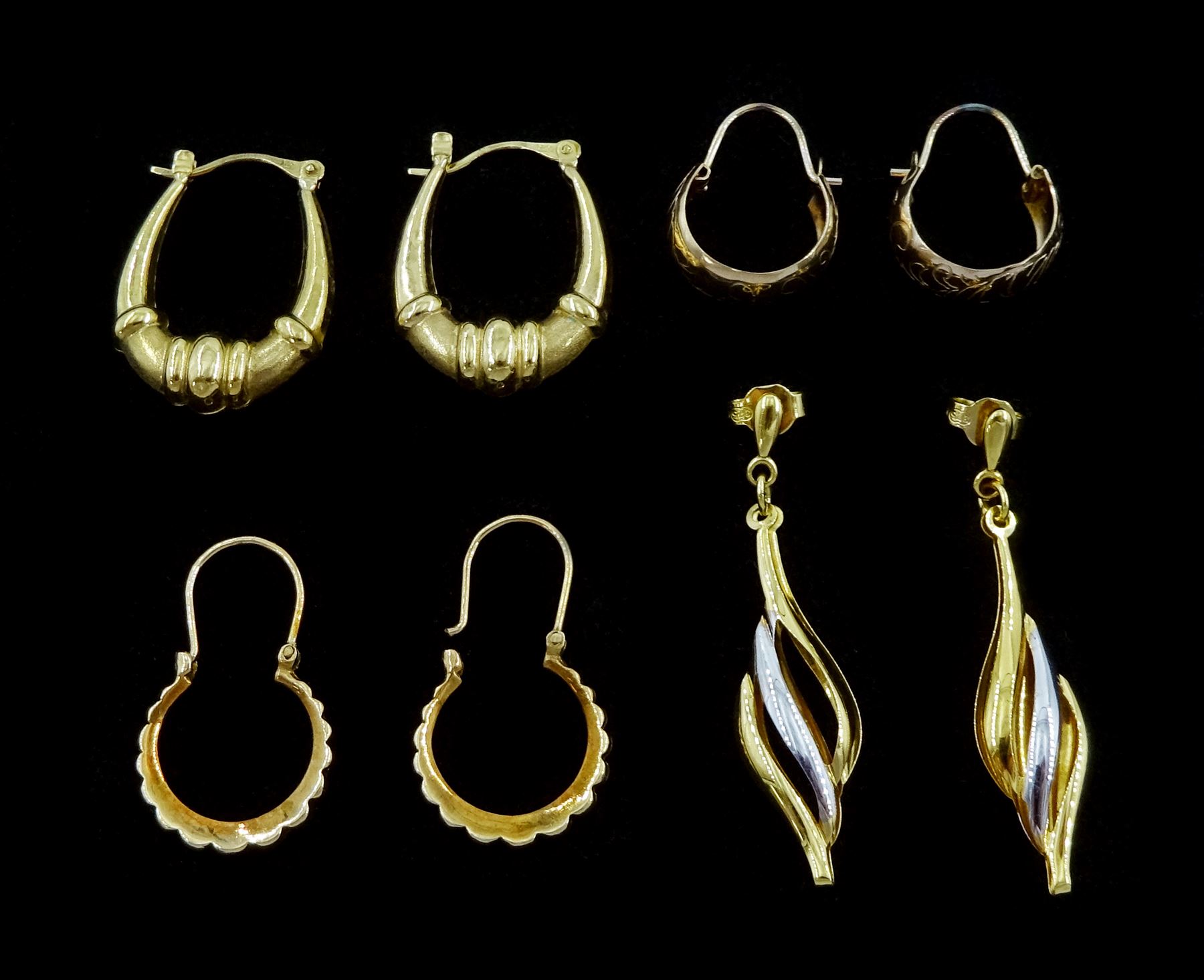 Three pairs of gold hoop earrings and one other pair of gold twist earrings