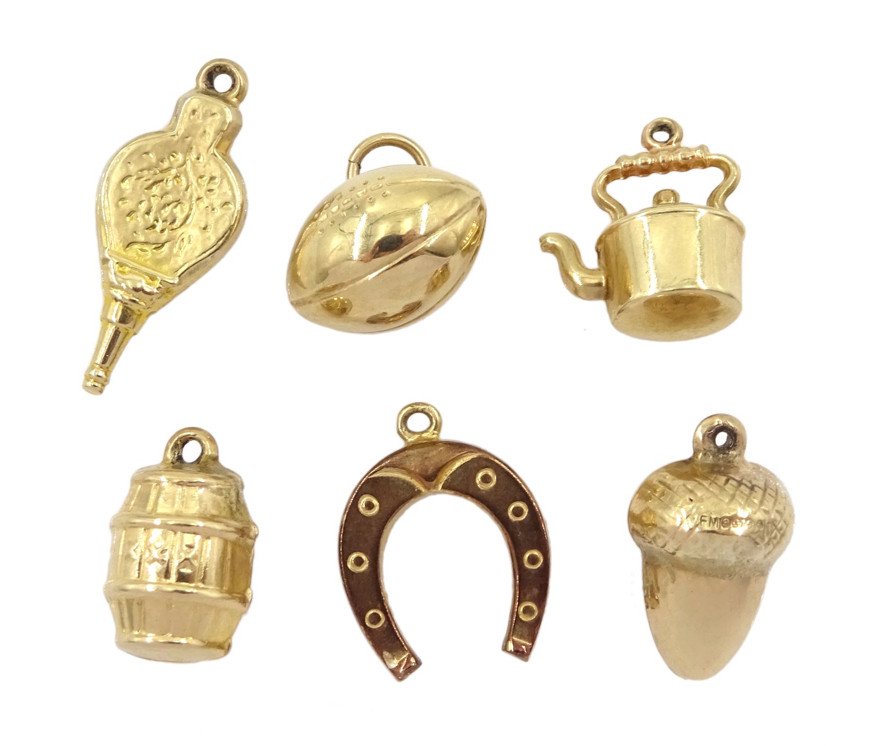 Six 9ct gold charms including acorn