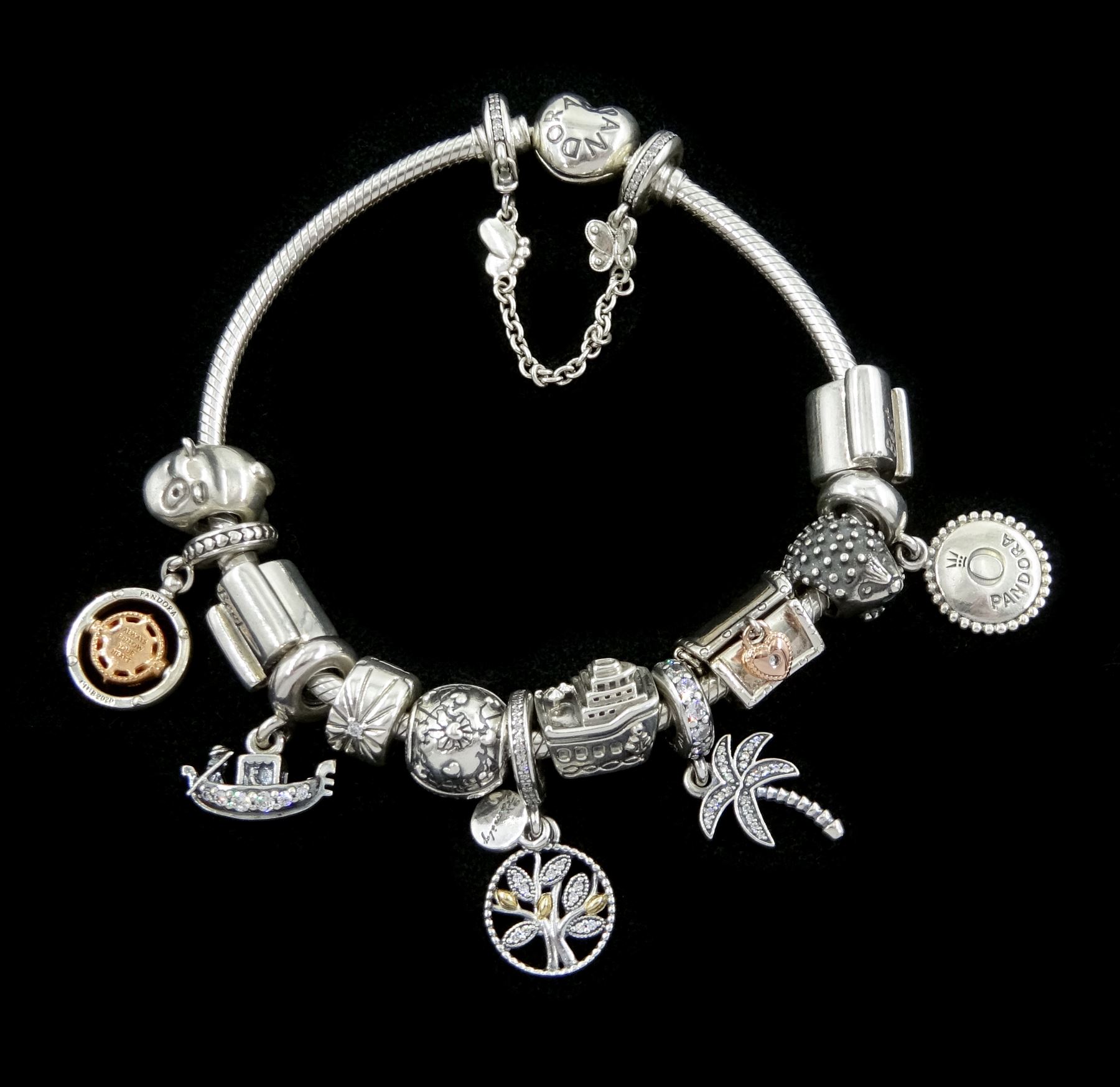 Pandora Moments heart clasp silver bracelet with thirteen silver Pandora charms and a silver Pandora