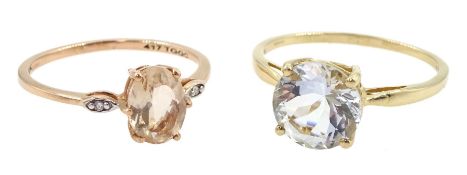 Gold single stone round aquamarine ring and a rose gold three stone morganite and diamond ring