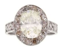 18ct white gold oval diamond and round brilliant cut diamond cluster ring