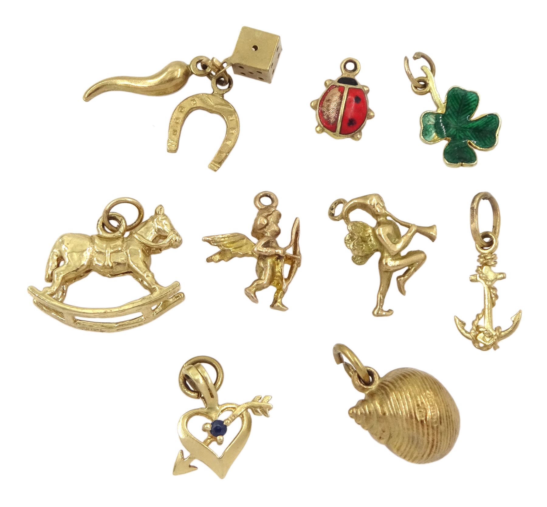 Nine 9ct gold charms including fairy