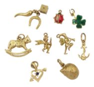 Nine 9ct gold charms including fairy