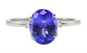 Platinum three stone oval tanzanite and round brilliant cut diamond ring