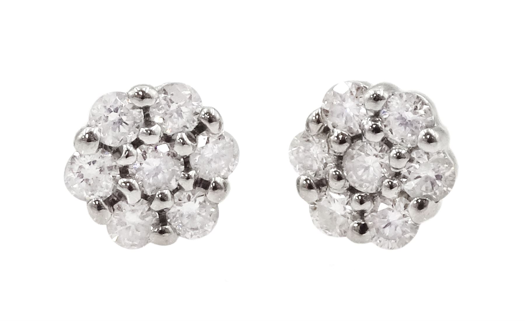 Pair of platinum round brilliant cut diamond flower cluster stud earrings