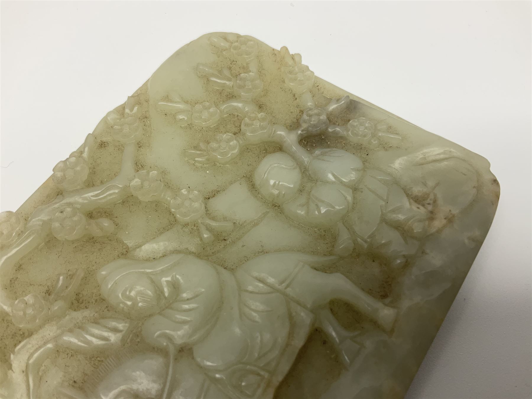 Pale celadon jade plaque carved in one side with a man riding his horse underneath flowering trees - Image 5 of 8