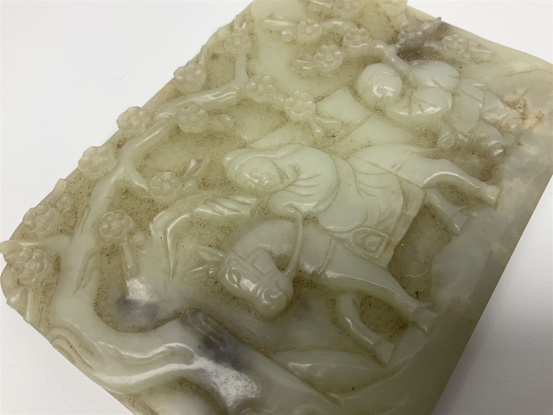 Pale celadon jade plaque carved in one side with a man riding his horse underneath flowering trees - Image 4 of 8