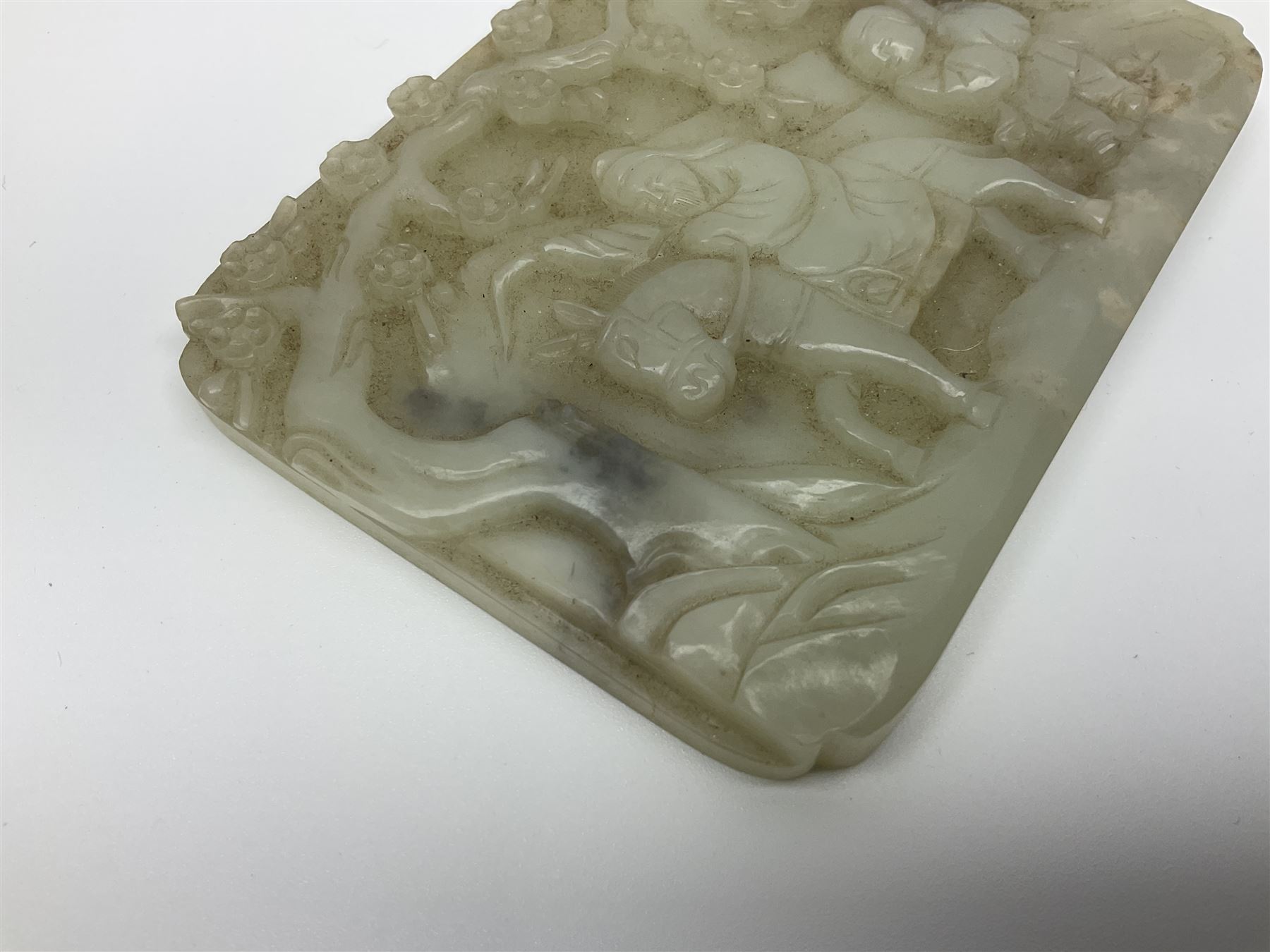 Pale celadon jade plaque carved in one side with a man riding his horse underneath flowering trees - Image 3 of 8