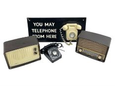 Vintage 1970s telephone mounted on board reading 'You May Telephone From Here'