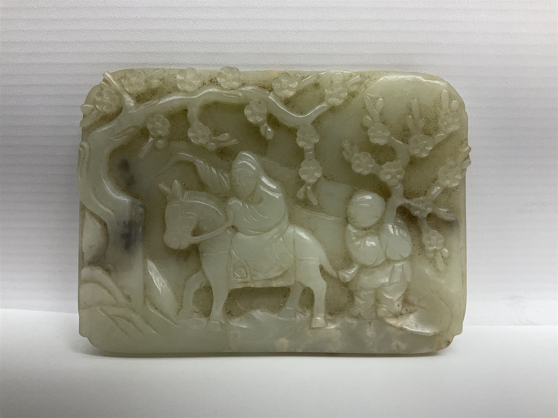 Pale celadon jade plaque carved in one side with a man riding his horse underneath flowering trees - Image 2 of 8