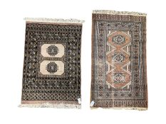 Person Bokhara lilac ground rug