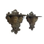 Pair cast iron wall mounted garden pot brackets in the form of putti