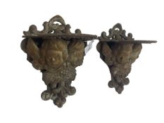 Pair cast iron wall mounted garden pot brackets in the form of putti