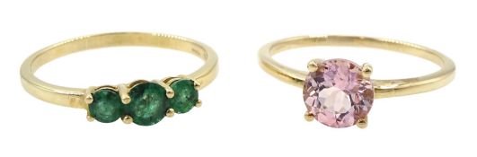 Gold three stone emerald ring and a gold single stone pink danburite ring