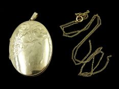 Gold oval locket pendant and a gold chain