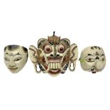 Three carved wooden Balinese topeng masks