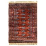 Persian Bokhara burnt amber ground rug