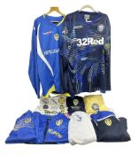 Fourteen items of replica sporting clothing including Leeds United football club shirts