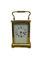 English - 20th century corniche 8-day brass cased carriage clock with an oval escapement viewing gla