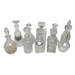 Ten decanters to include an I.W. Harper example of concave square form and two examples with tags