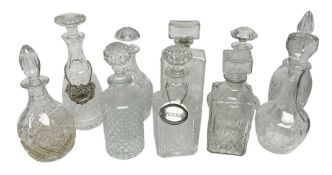 Ten decanters to include an I.W. Harper example of concave square form and two examples with tags