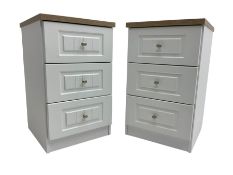 Pair of narrow oak and white finish three drawer bedside chests