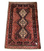 Persian indigo and crimson ground rug
