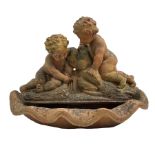 Terracotta garden fountain in the form of putti on a naturalist base