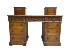 Late 19th century heavily carved oak twin pedestal desk