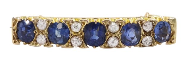 Early 20th century 10ct gold graduating five stone oval cut sapphire and old cut diamond brooch