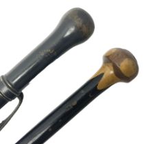 Two ebonised walking sticks