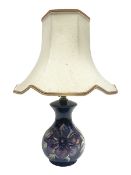 Moorcroft table lamp in anemone pattern upon a blue ground