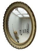 Convex wall mirror in cream and gilt finish frame