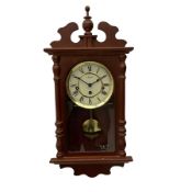 A contemporary 21st century wall clock in a mahogany finished case with a fully glazed door
