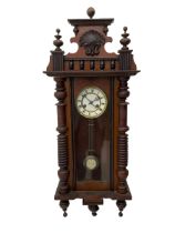 German spring driven wall clock c1900 within a glazed case with side panels and a full-length arched