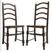 Pair of oak arched ladder back chairs with rush seats on turned supports