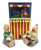 Two Japanese battery operated tin-plate drummers as a plush covered duck and a clown in a felt suit;
