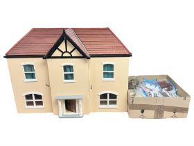 Scratch-built wooden doll's house of double fronted form with simulated stucco walls under a faux ti