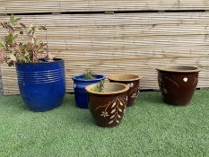 Set of five different size glazed planters