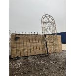 Two wrought iron garden gates painted in black and white