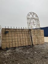 Two wrought iron garden gates painted in black and white