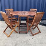 Hardwood drop leaf garden table on castors and folding chairs