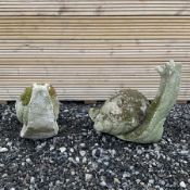 Two cast stone snail ornaments